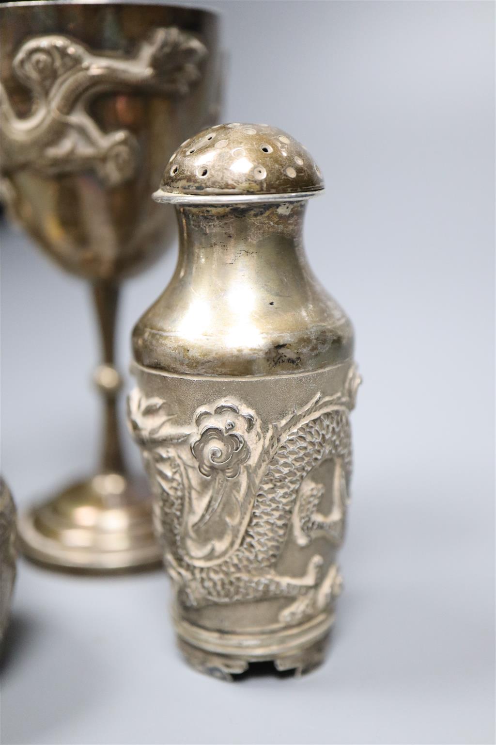 A pair of Chinese white metal pepperettes, 7cm, a similar salt, small goblet and a coin.